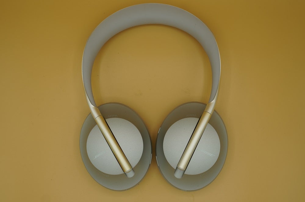 Bose Noise Cancelling Headphones 700 flatView from top, of silver-white Bose NC700 headphone's earpad's back side
