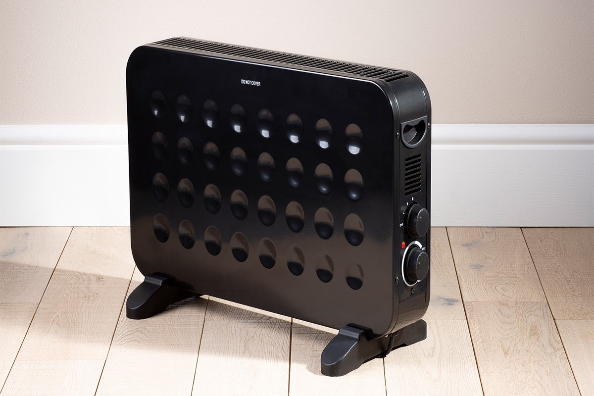 Right angled view of a black Fine Element contemporary convector heater standing on floor