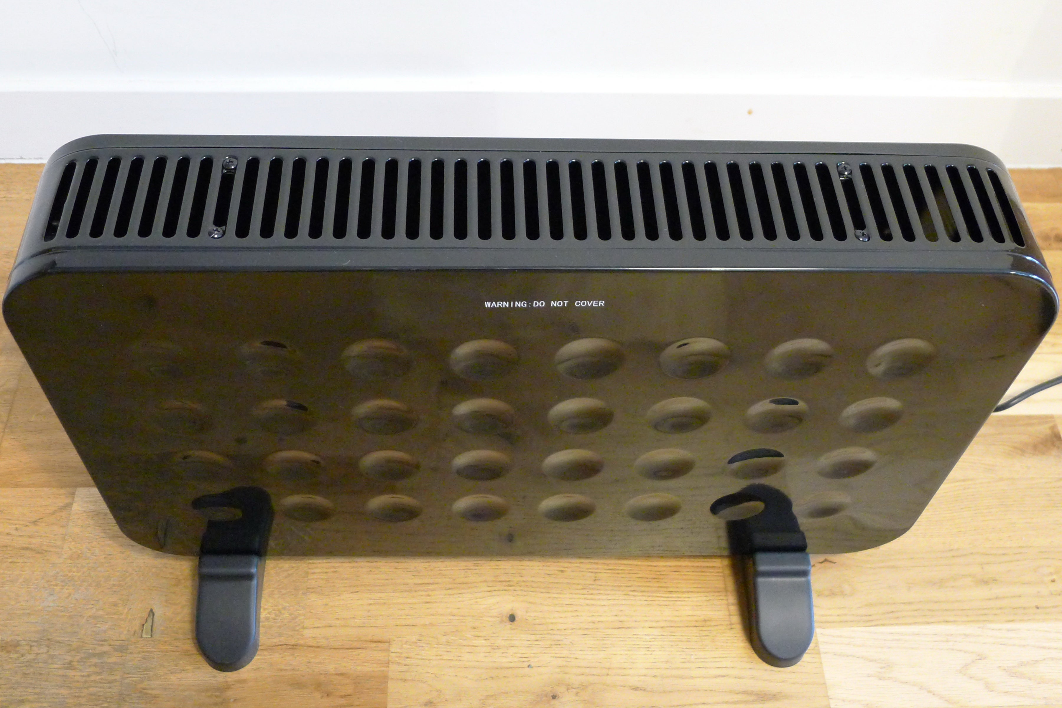 Top front view of a black Fine Element contemporary convector heater standing on floor