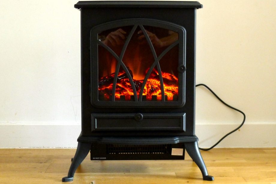 A black Fine Element stove heater standing on floor