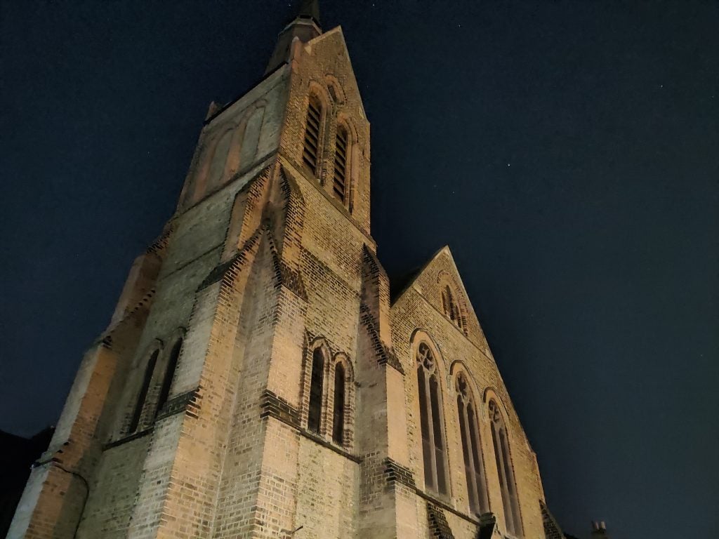 A big church with brick texture taken from bottom to top view, picture taken at night, clear