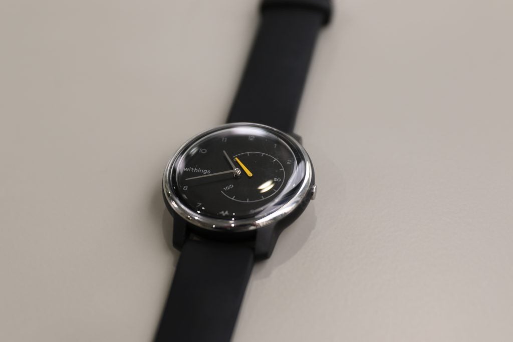 Close up view of a black Withings Move ECG watch kept on a white table