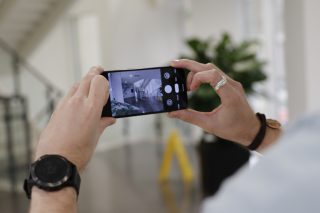 A Pixel 4 held in hand displaying picture through camera