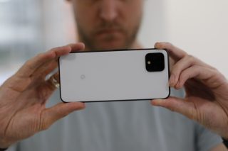 Back panel view of a Pixel 4 held in hand horizontally facing back