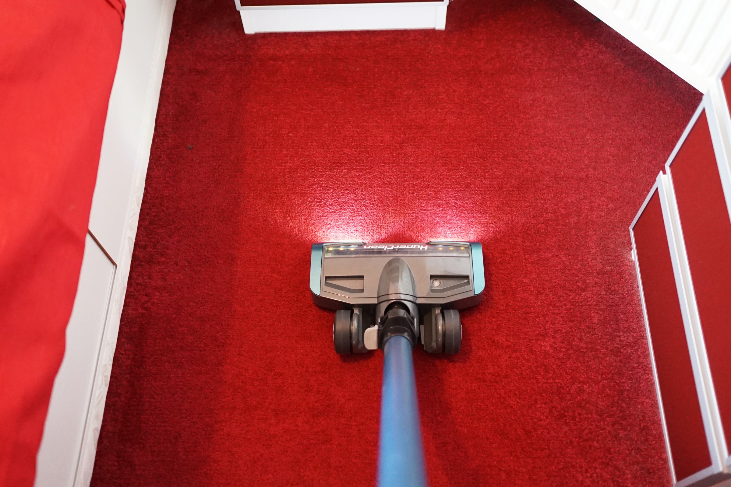 A Swan Hyperclean Eureka being used on a red carpet in a bedroomA complete set of Swan Hyperclean Eureka kept on wooden floor with packaging box