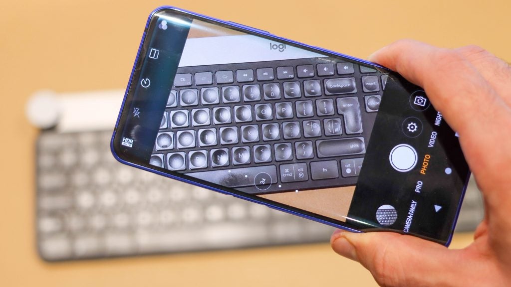 A blue ZTE Nubia Z20 held in hand horizontally displaying a picture of keyboard through camera