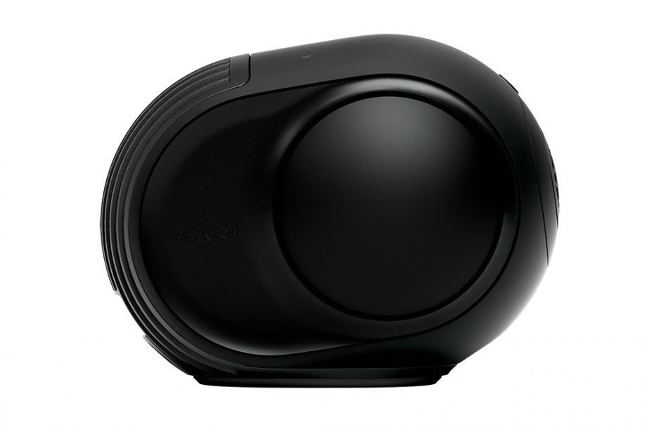 Side view of a black Devialet Phantom II wireless speaker kept on a white background