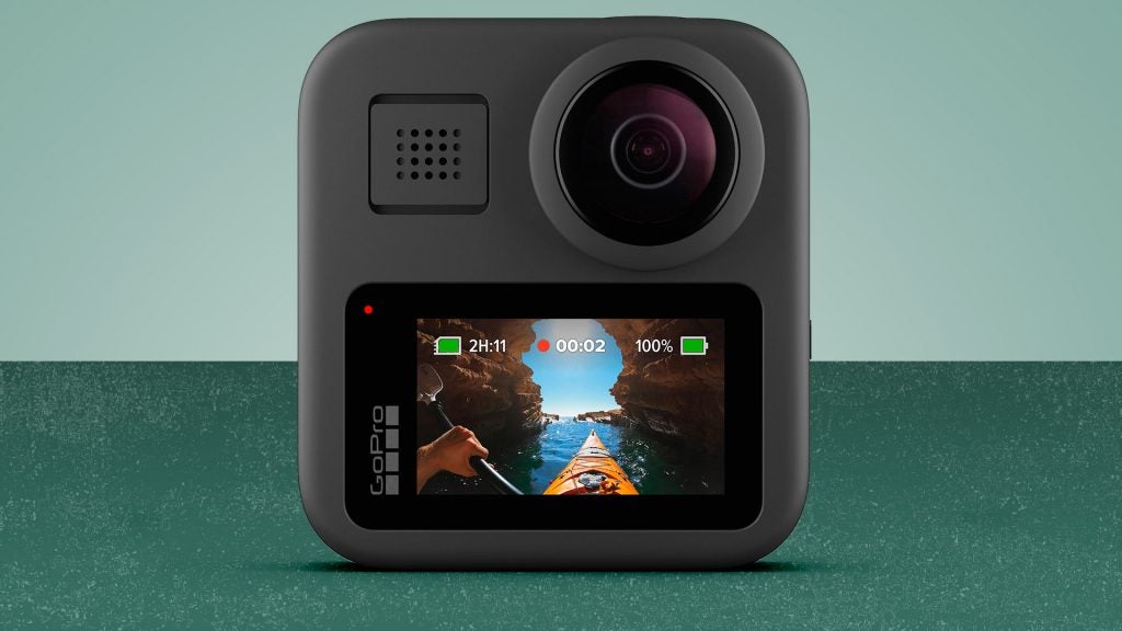 A black GoPro Max camera standing on a green background