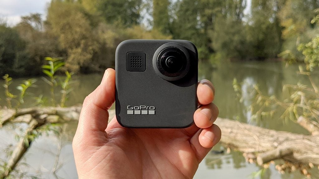 A gray GoPro Max camera held in hand