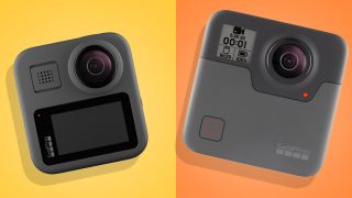 Two different gray GoPro cameras kept on yellow and orange background