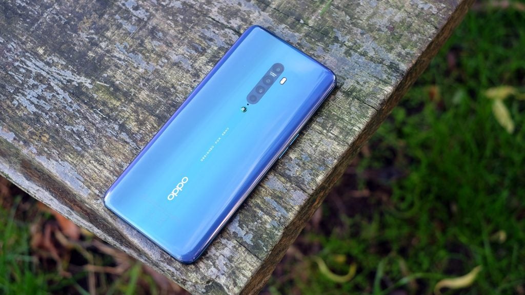 Right angled view from top of a blue Oppo Reno 2 kept facing down on a wooden surface