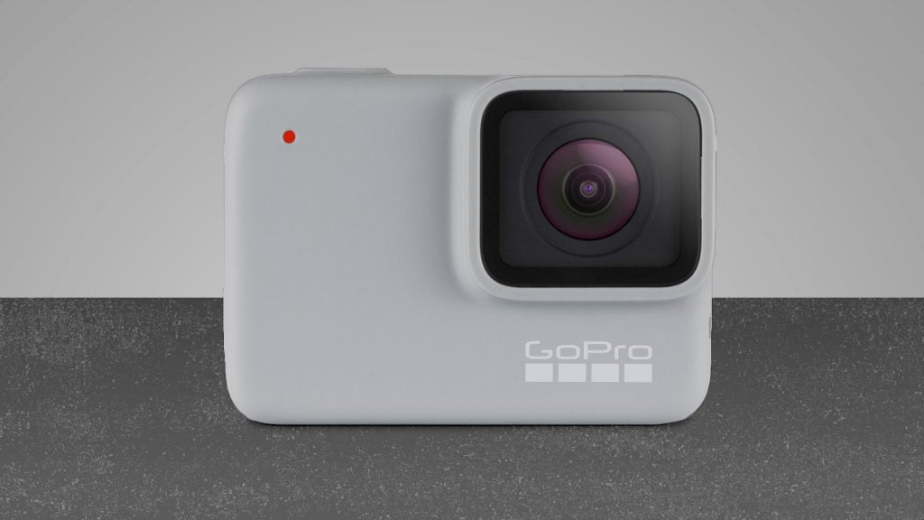A white GoPro Hero 8 camera standing on gray-silver background
