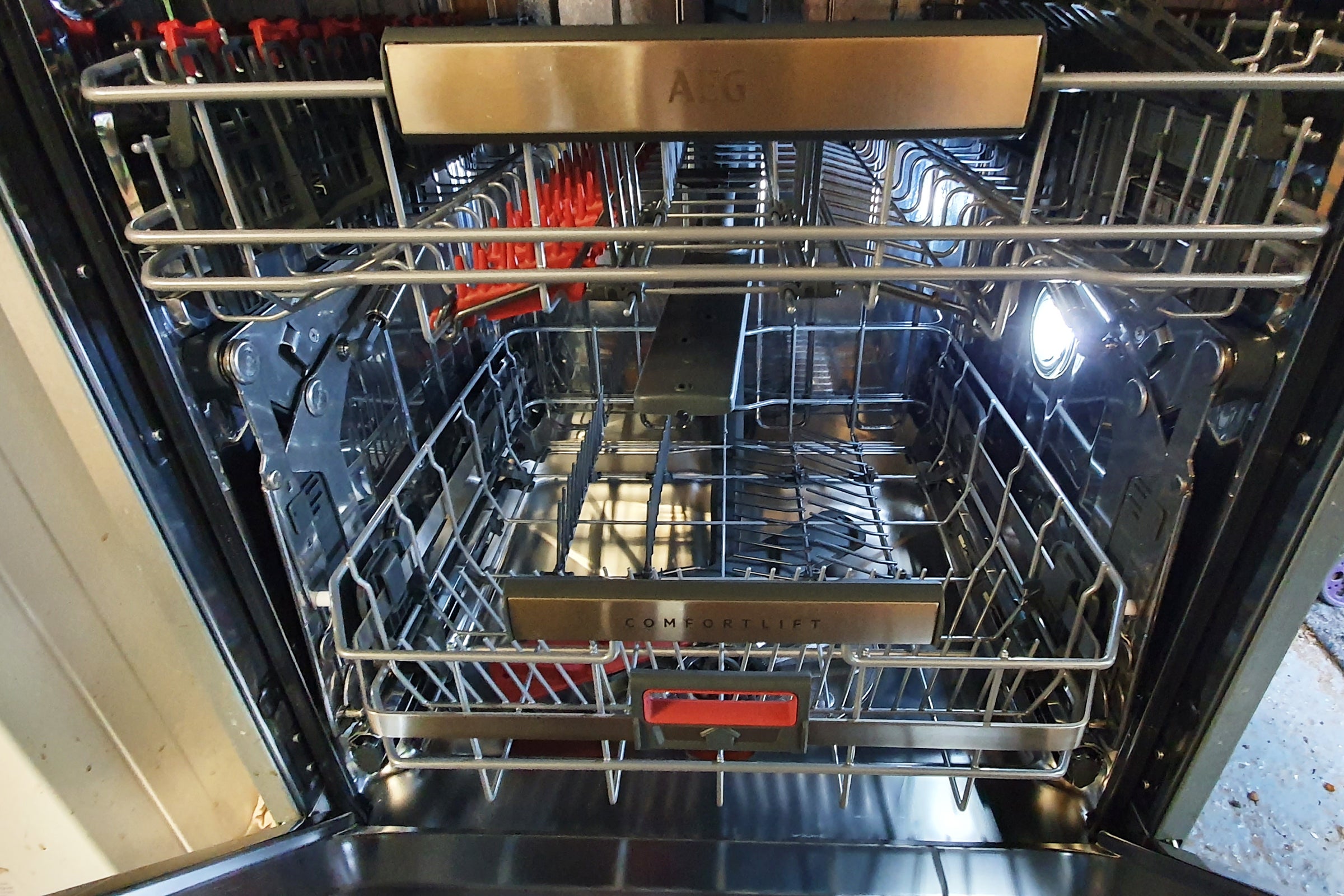 AEG ComfortLift Integrated Dishwasher interiorInside view of AEG dishwasher with lights turned on