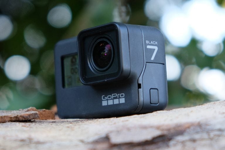 Side view of a black GoPro GPH7 standing on ground