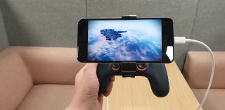 A smartphone attached to a gaming controller displaying game on Google Stadia