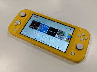 A yellow Nintendo Switch kept on a white table displaying deadly premonitions origin screen