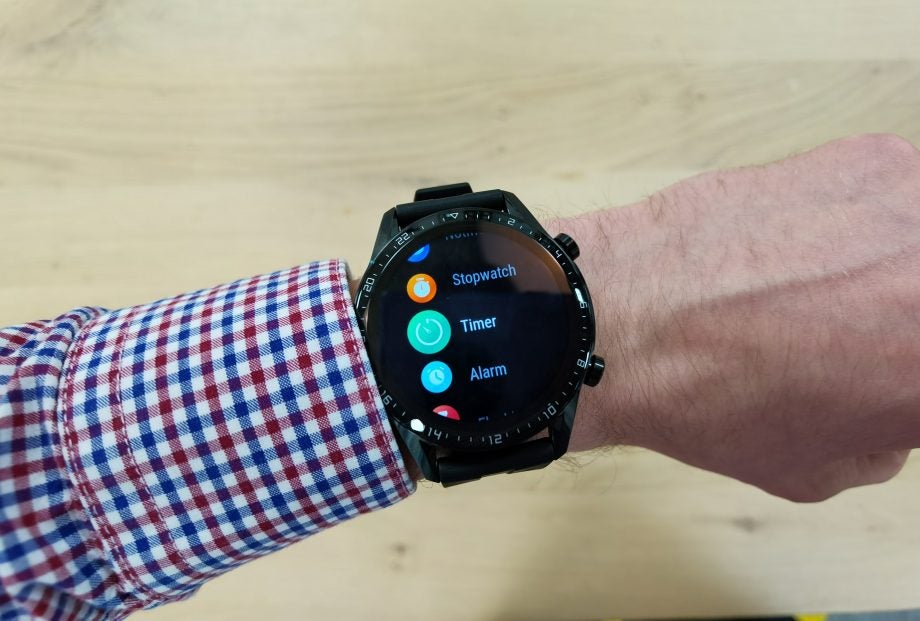A black Huawei Watch GT 2 wore on hand displaying menu screen