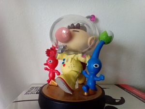 Figurine of a boy and aliens beside him, small toy statue