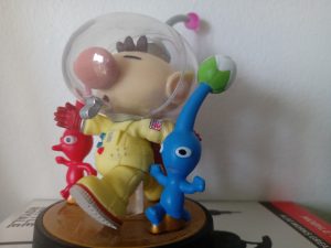Figurine of a boy and aliens beside him, small toy statue