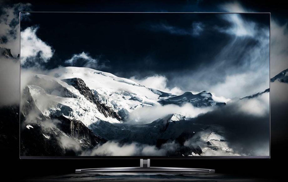A silver LG 75SM99 TV displaying snow mountains