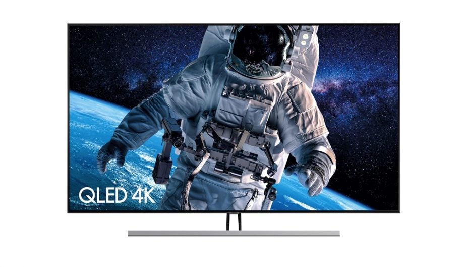 A black Samsung Q85R TV standing on white background
