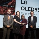 Two women receiving award from two men on stage, LG OLED55C9 displayed on screen behind, Trusted Reviews Awards