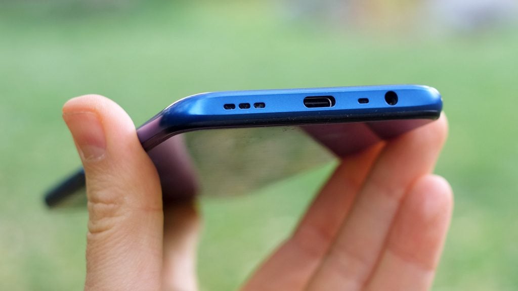 Bottom edge view of a blue Oppo A9 held in hand