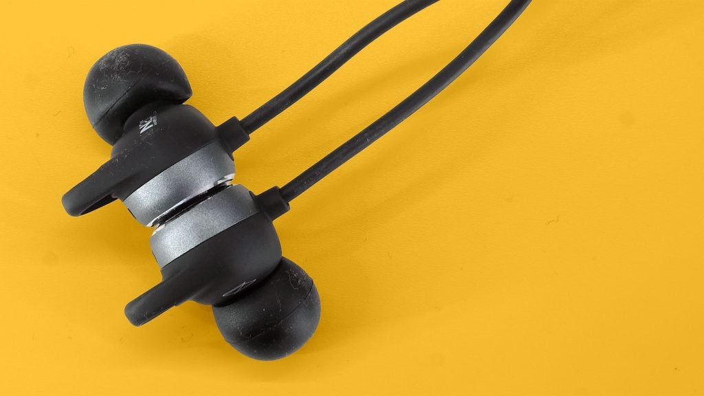 AKG N200NCClose up view of earbuds of AKG N200NC wireless earphones kept on a yellow table