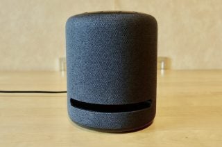 A gray Echo Studio smart speaker standing on a table