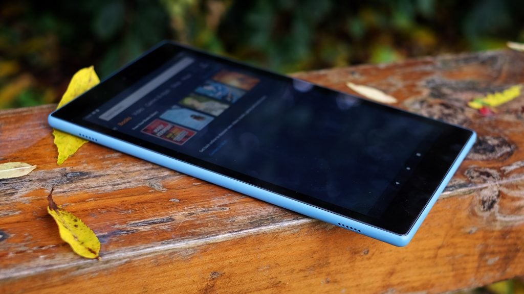 fire hd 10 2019Left side edge view of a blue Fire HD 10 tablet kept on a wooden surface displaying books menu screen