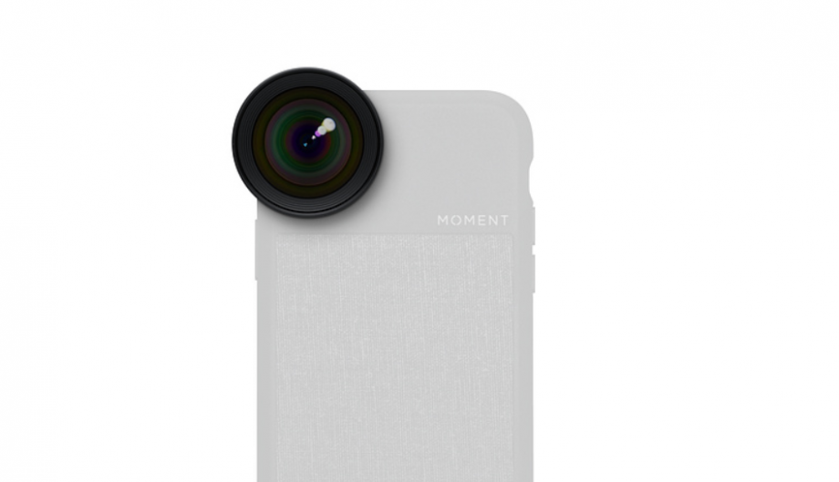 A black lens fixed on a white iPhone on white background showing iPhone lens attachment