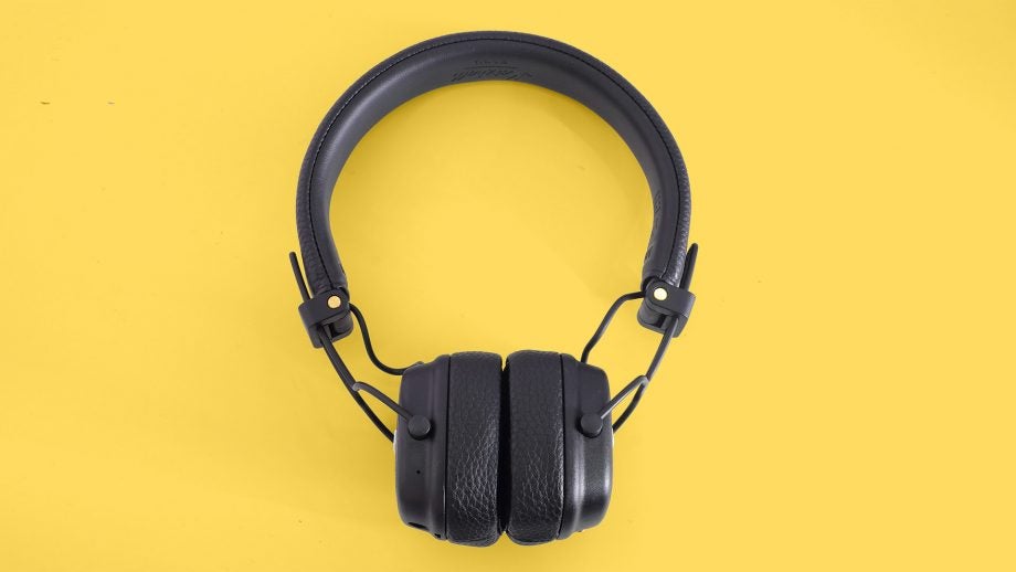 View from top of black headphones kept on a yellow table