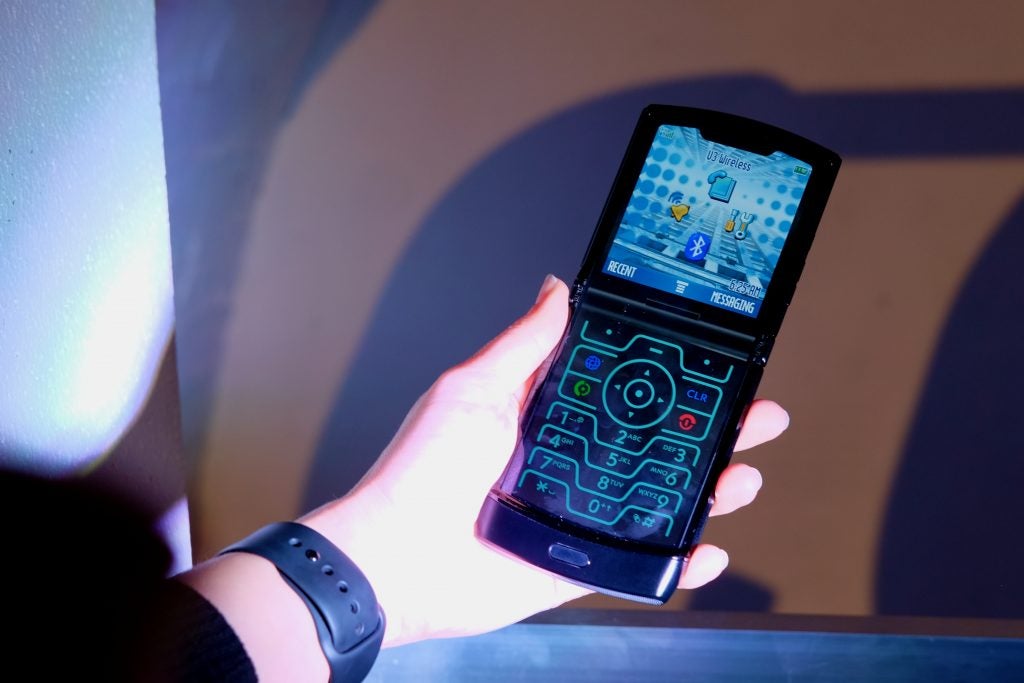 A Motorola Razr held in hand in displaying Retro Razr skin