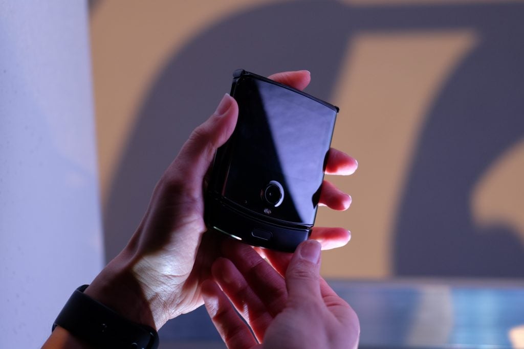 A Motorola Razr held in hand in folded state
