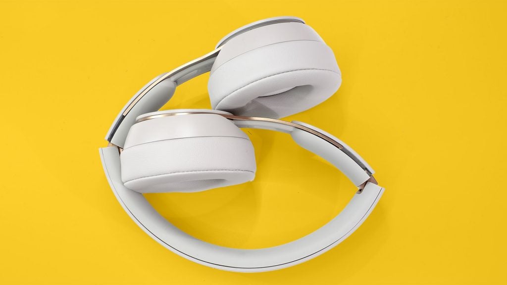 Beats Solo ProView from top of white Beats headphones kept on a yellow background