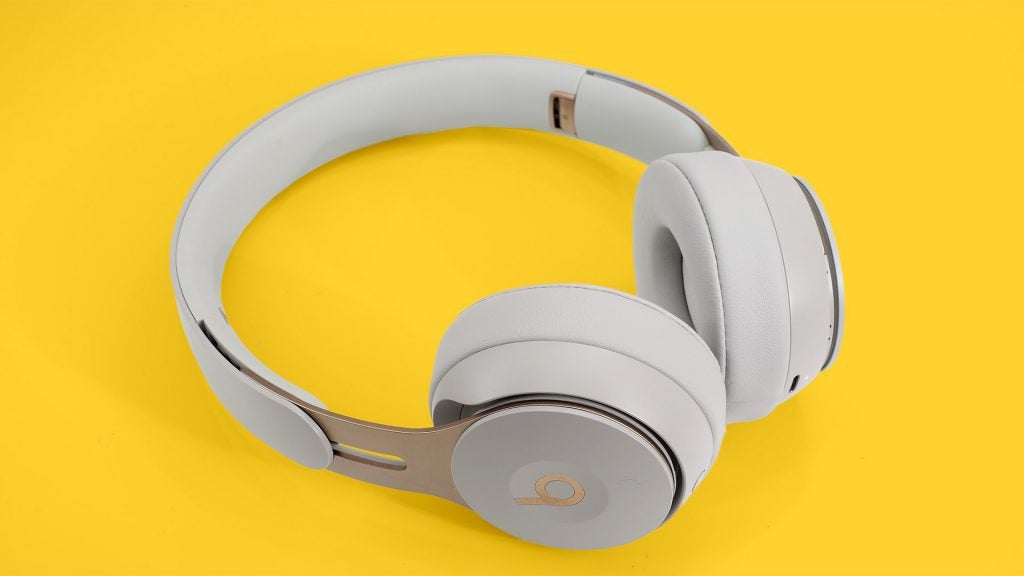 Beats Solo ProLeft angled view from top of white Beats headphones kept on a yellow background