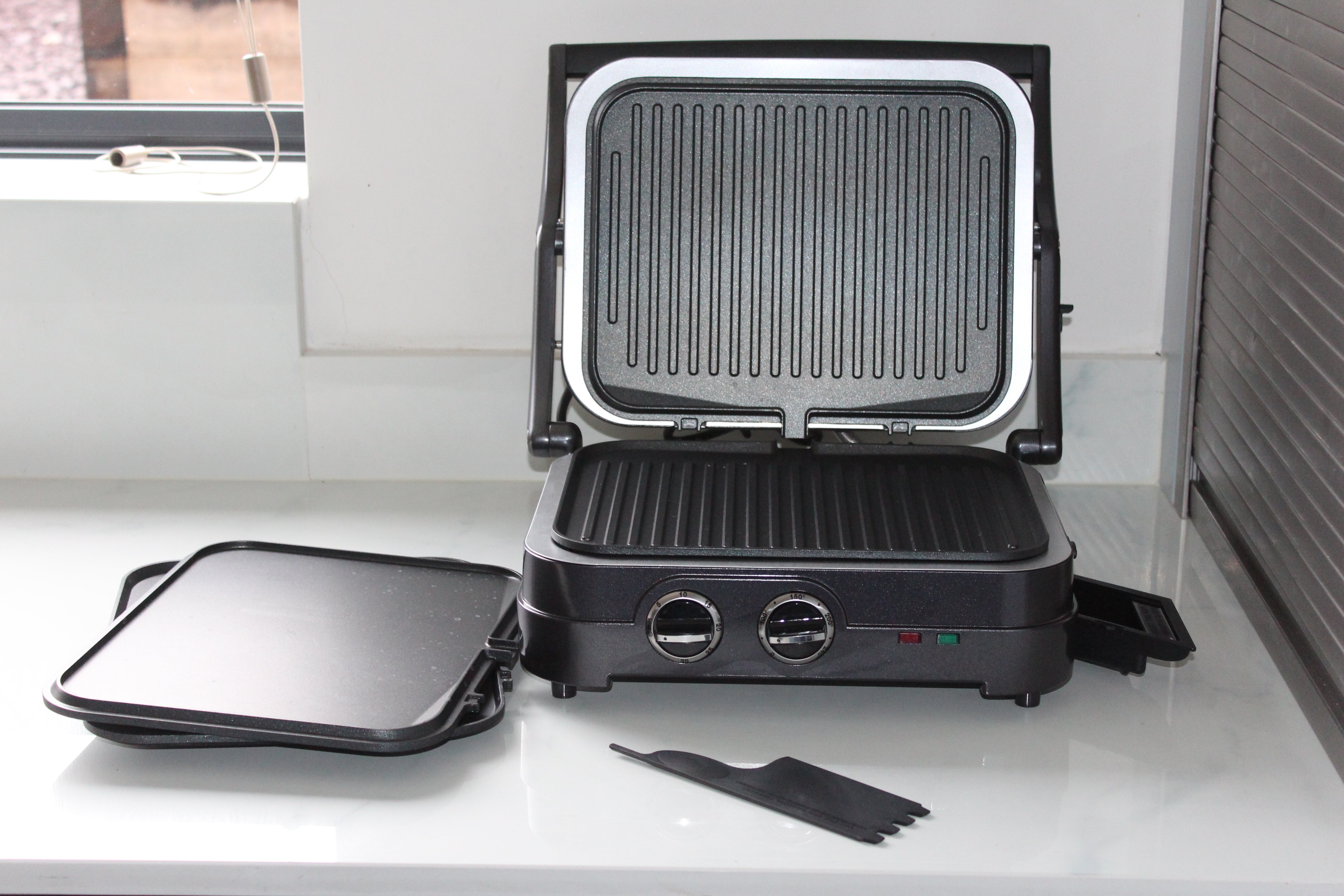 Cuisinart Griddle & Grill accessoriesPicture of a gray-black Cuisinart GR47BU Griddle-Grill kept disassembled on a kitchen platform