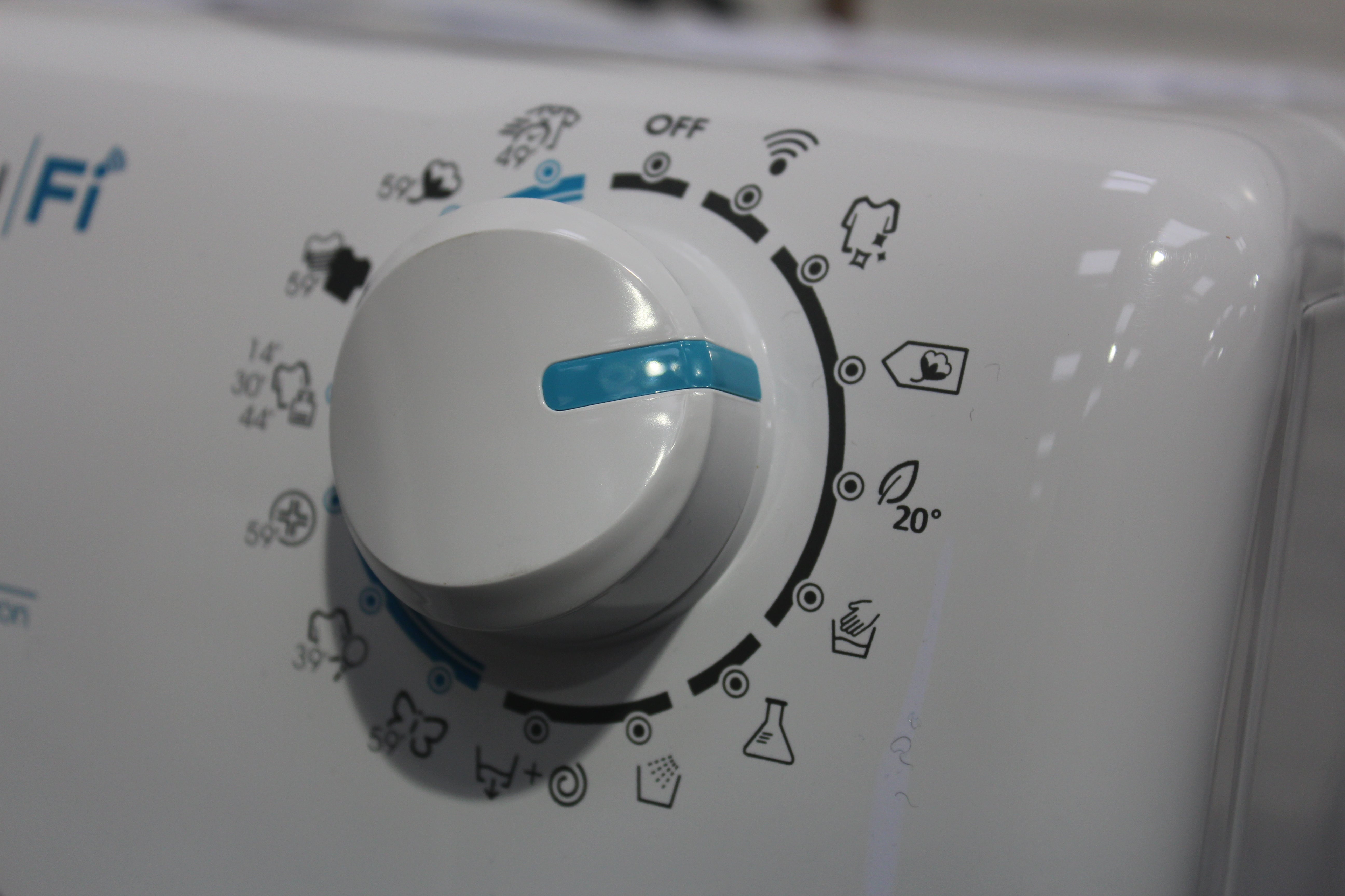 Close up picture of a rotating knob on a white Candy Smart Pro washing machine