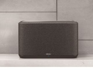 Picture of a black Denon Home 350 LS speaker standing on a shelf