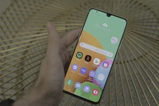 Picture of a Samsung Galaxy A90 held in hand displaying homescreen