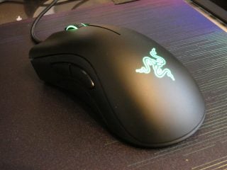 Side top view of a black Razer DeathAdder Essential mouse kept on a table
