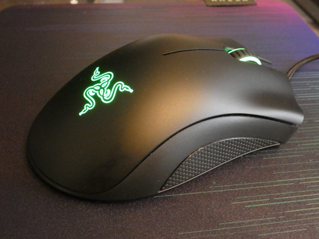 Side top view of a black Razer DeathAdder Essential mouse kept on a table