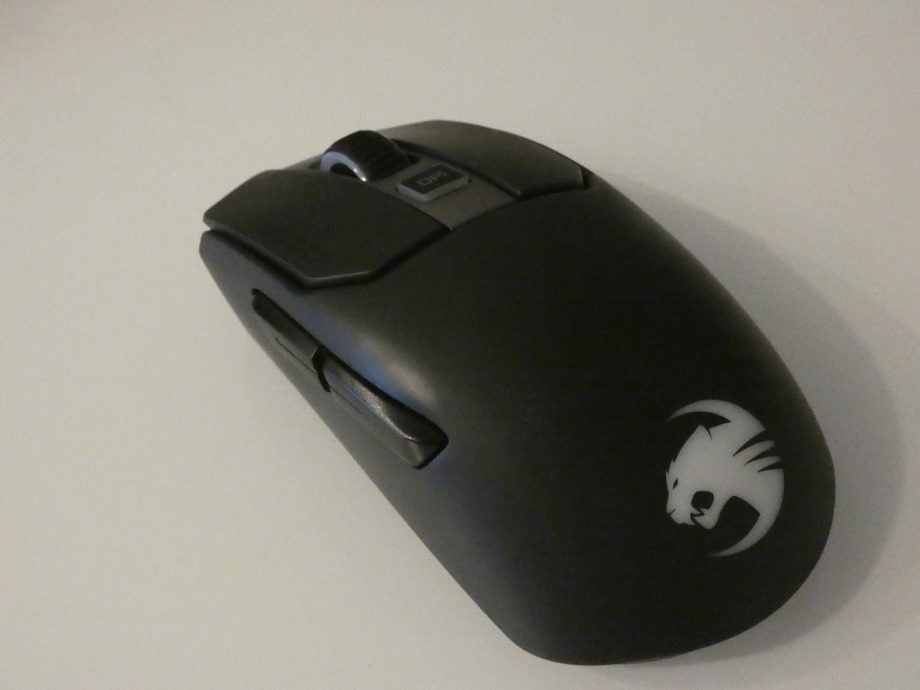 Left-top side view of a black Roccat Kain 200 mouse kept on a table with buttons on left edge