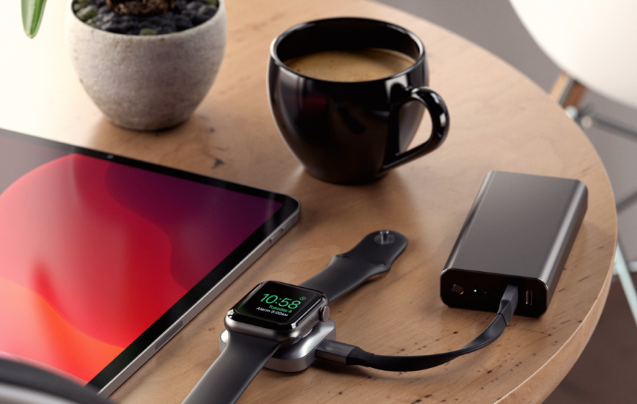 A picture of a USB-C magnetic charging dock kept on a table connected to a Powerbank and charging an Apple watch