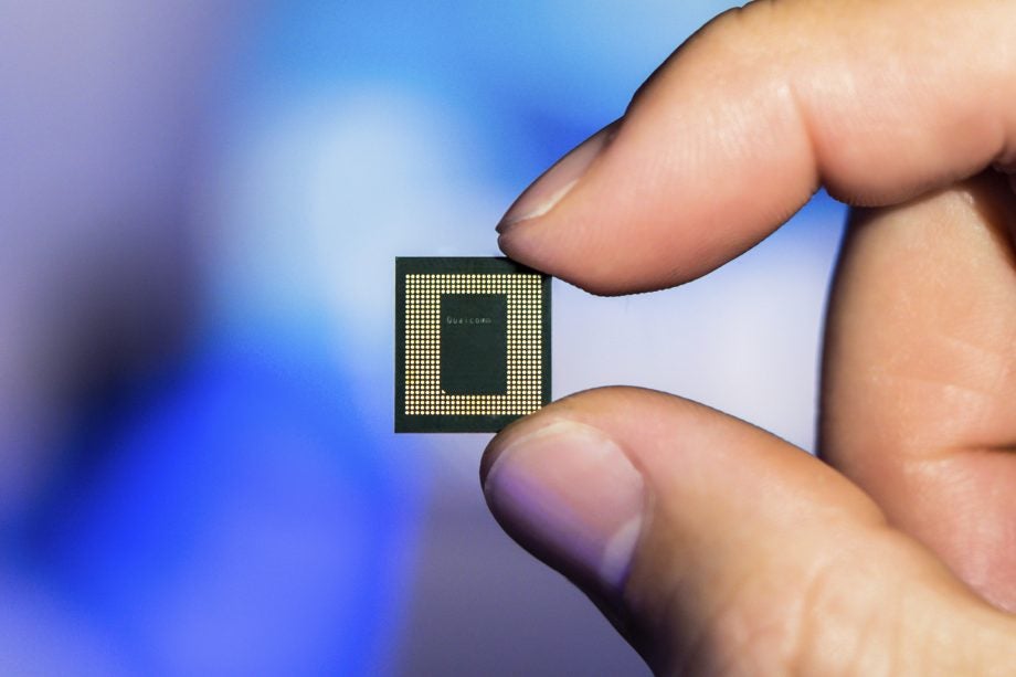A Qualcomm Snapdragon 865 chip held between fingers