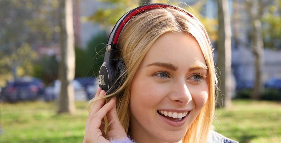 A picture of a girl wearing JBL Reflect Eternal headphones