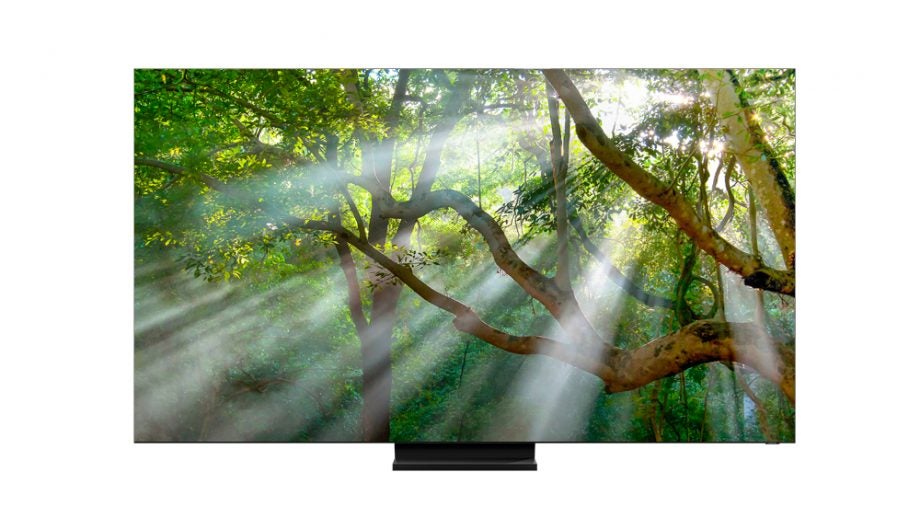 A black Samsung QLED 8K Q950 TV standing on white background displaying a picture of a forest