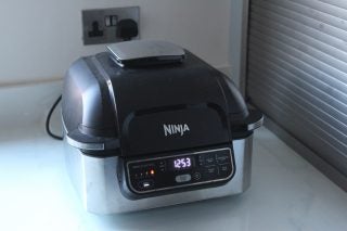 Picture of a silver-black Air Fryer AG301UK kept on a kitchen platfrom