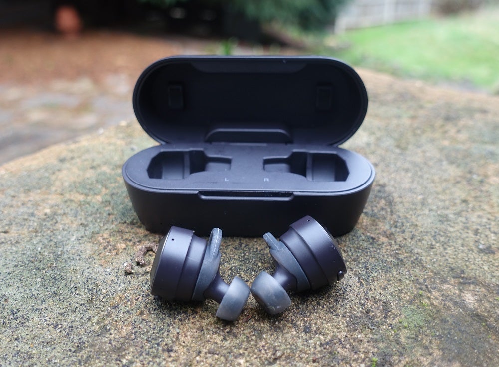 ATH-CKS5TWBlack Audio Technica CKS5TW earbuds with it's case behind kept on ground
