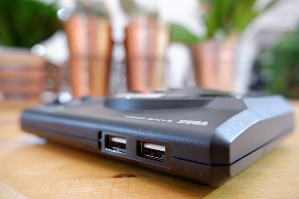 Close up image of ports section of a black Sega Mega Drive Mini kept on a table